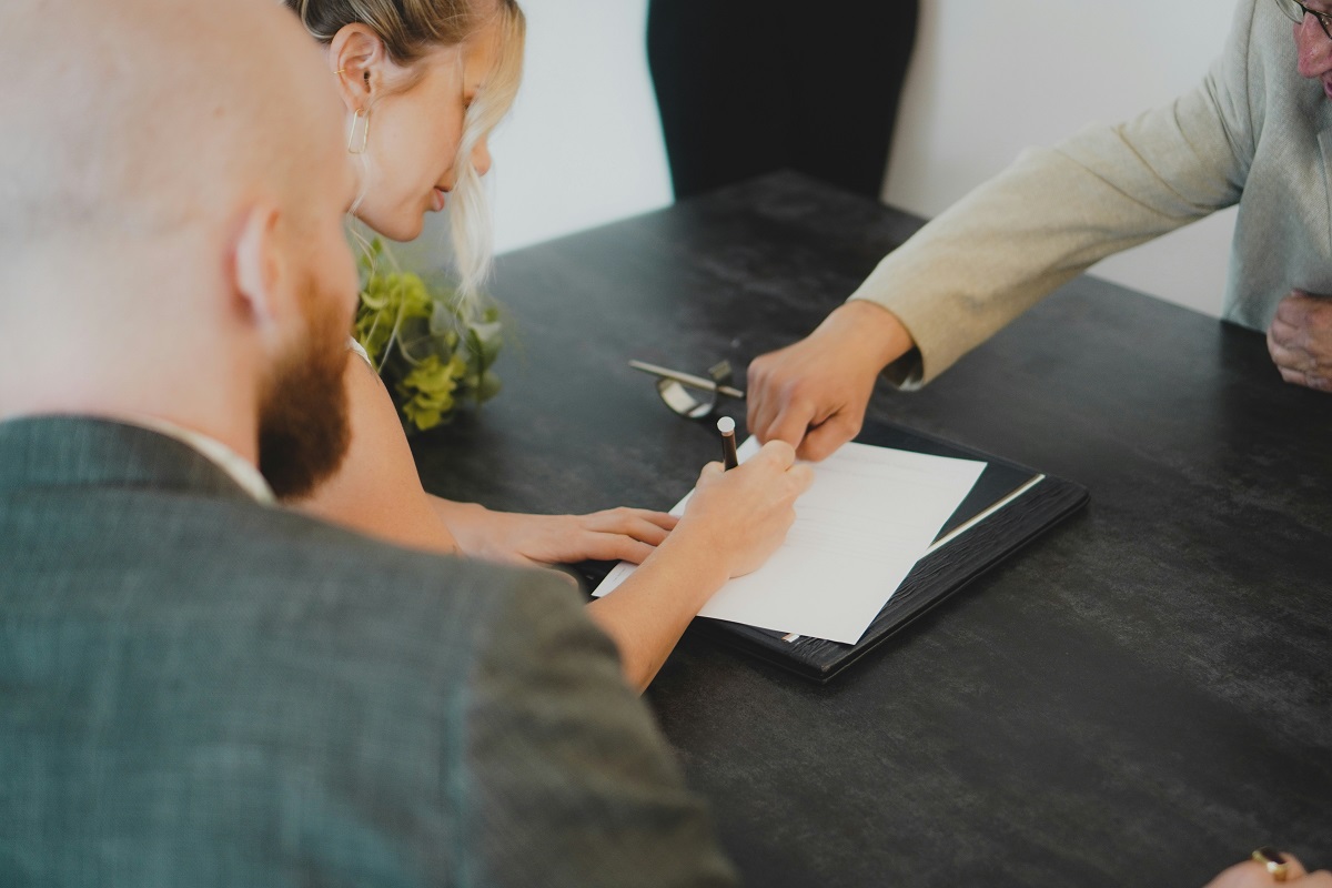 woman signing divorce papers