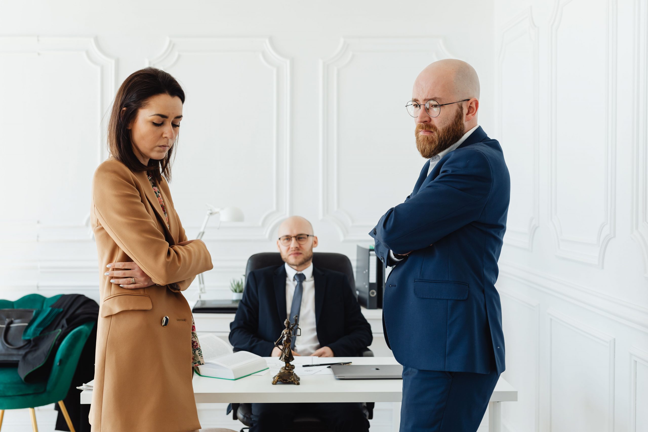 stressed couple standing in front of a divorce lawyer